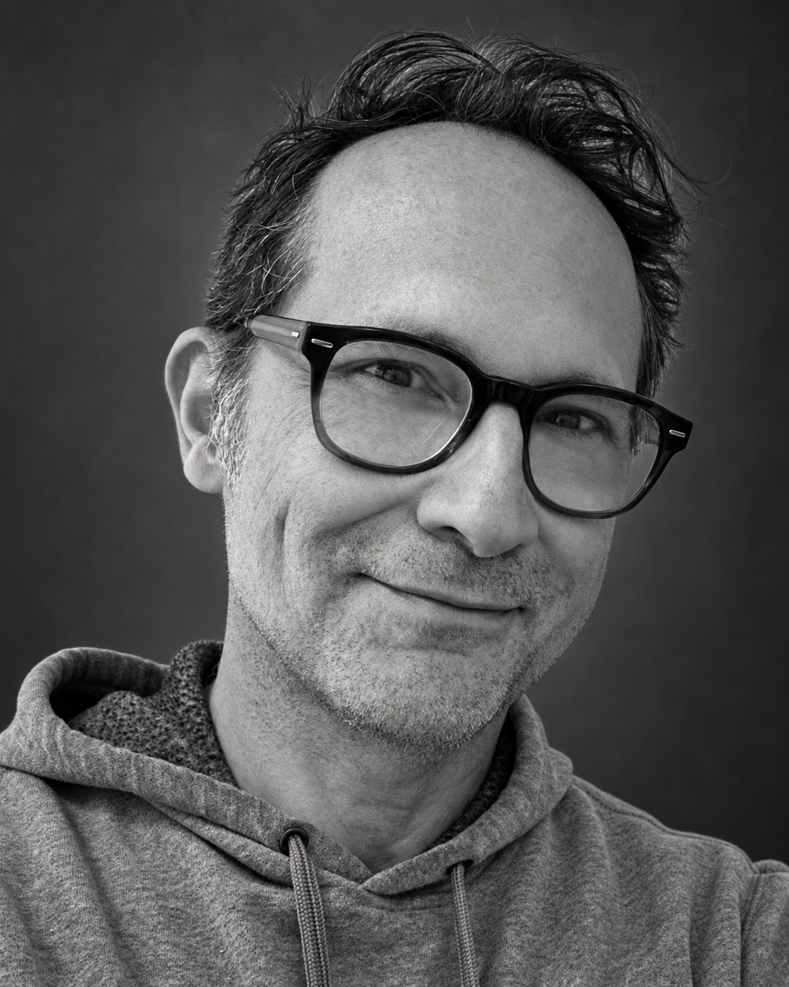 Black-and-white portrait of Anthony Haden Salerno wearing glasses and a hoodie